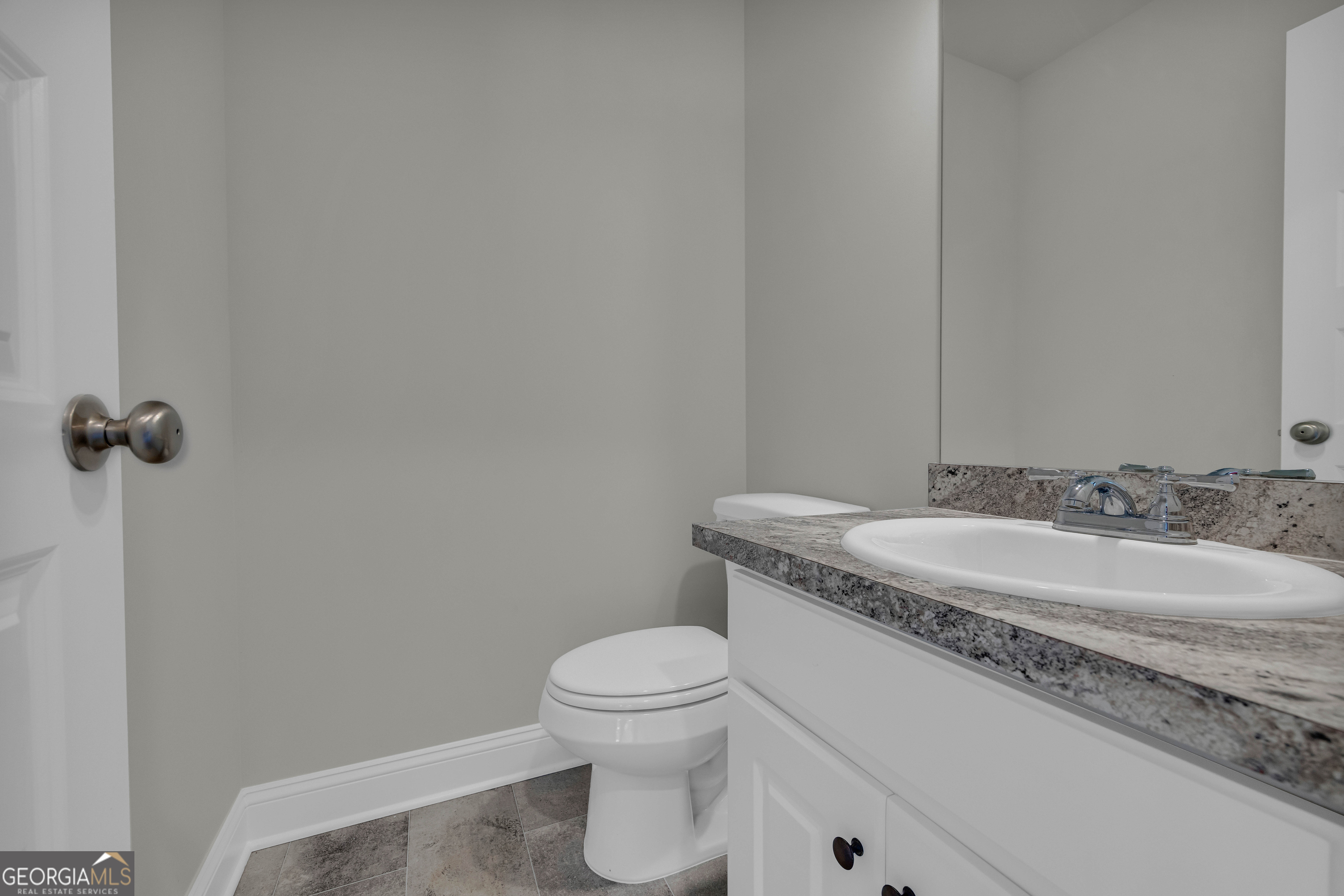 62 Sewell Road Lavonia, GA 30553 - Photo 7 of 63 a bathroom with a granite countertop sink a toilet and mirror