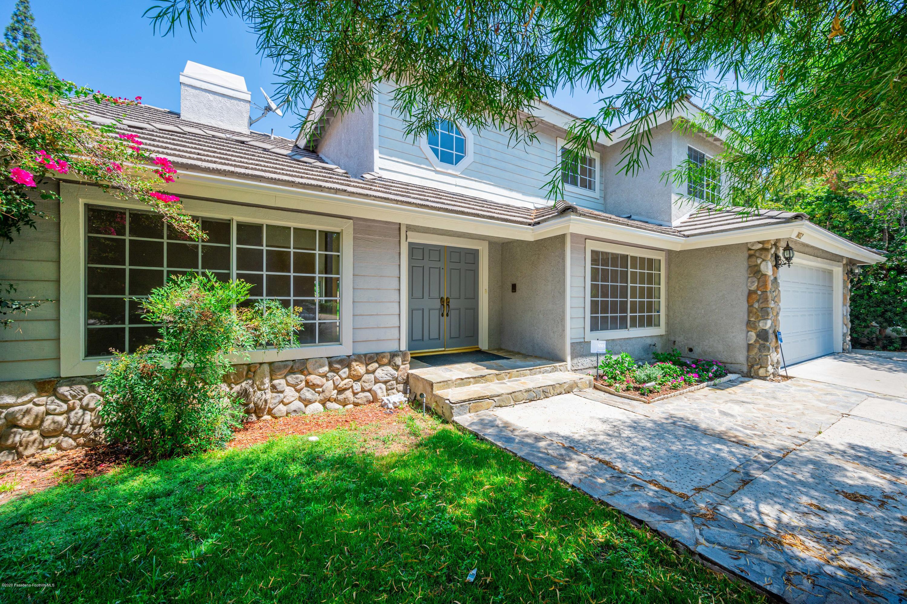 10652 Rathburn Avenue Porter Ranch, CA 91326 - Photo 1 of 61 a front view of a house with garden