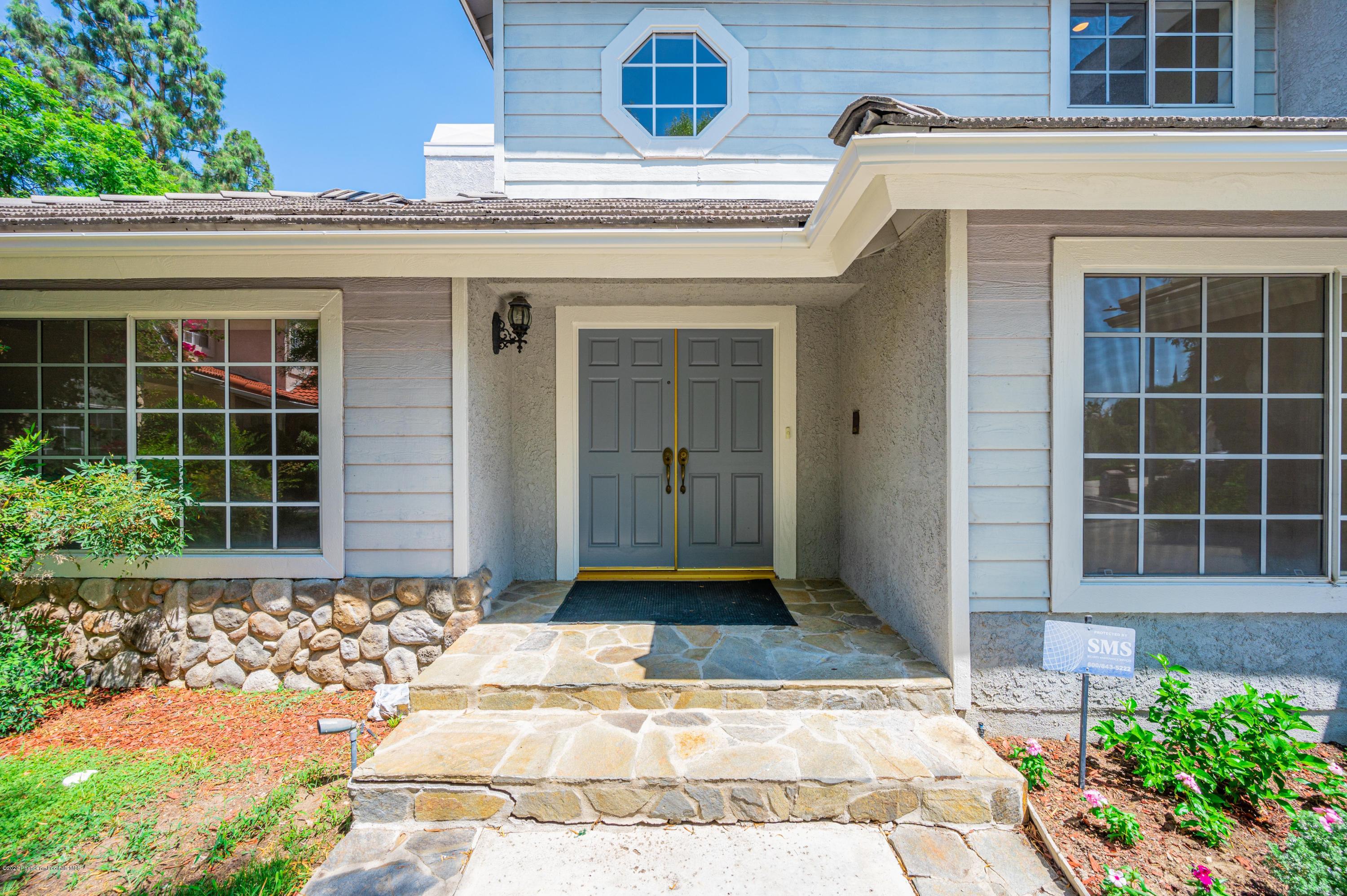 10652 Rathburn Avenue Porter Ranch, CA 91326 - Photo 2 of 61 a front view of a house with a yard