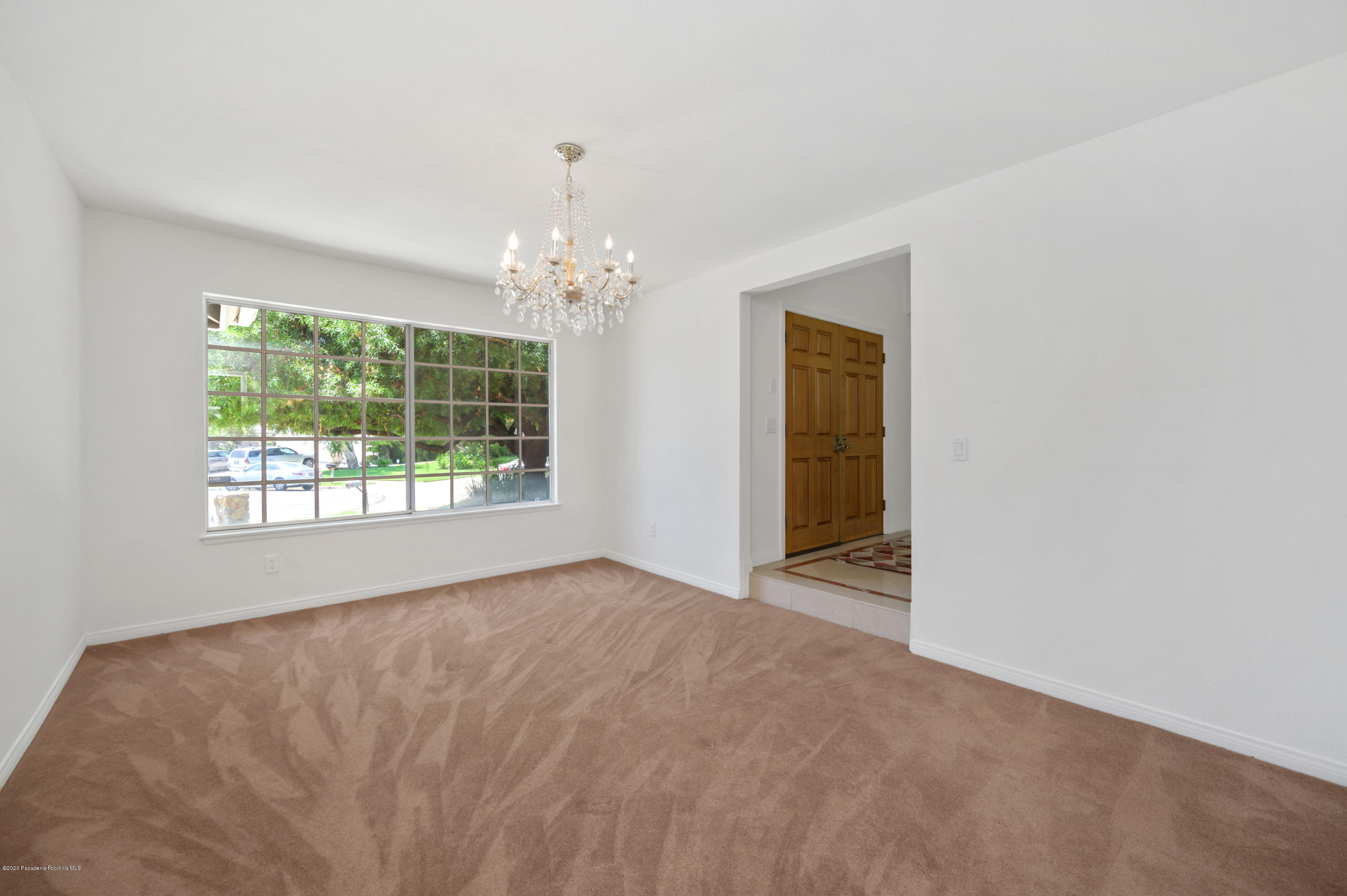 10652 Rathburn Avenue Porter Ranch, CA 91326 - Photo 11 of 61 a view of an empty room with window and chandelier fan
