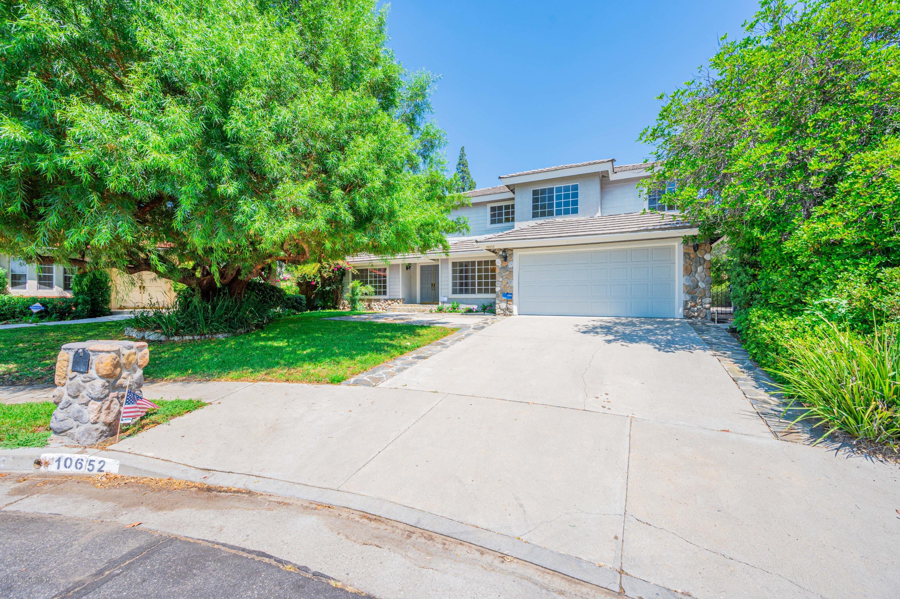 10652 Rathburn Avenue Porter Ranch, CA 91326 - Photo 3 of 61 front view of house with a yard and potted plants
