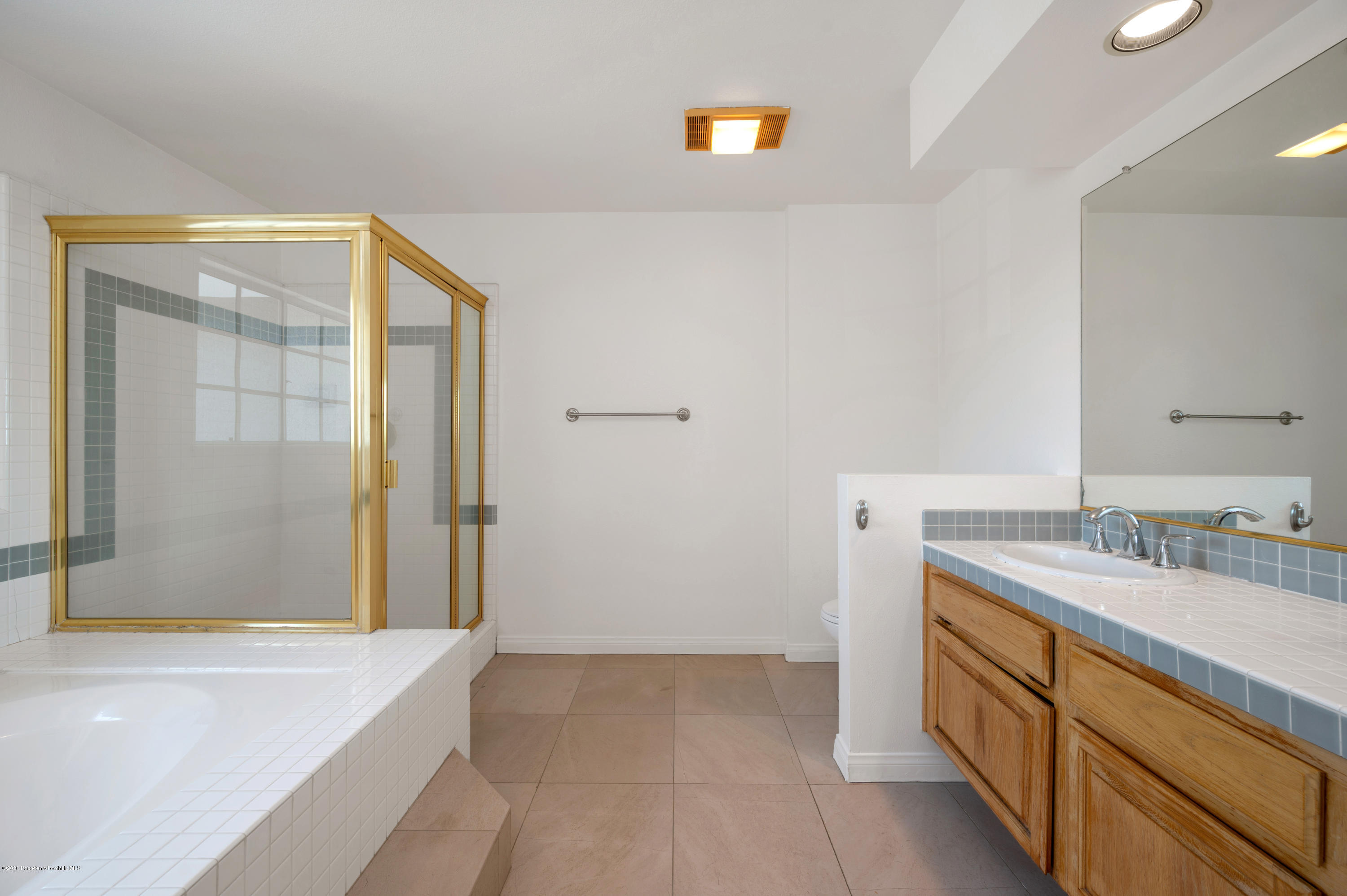 10652 Rathburn Avenue Porter Ranch, CA 91326 - Photo 29 of 61 a bathroom with a granite countertop sink and a bathtub