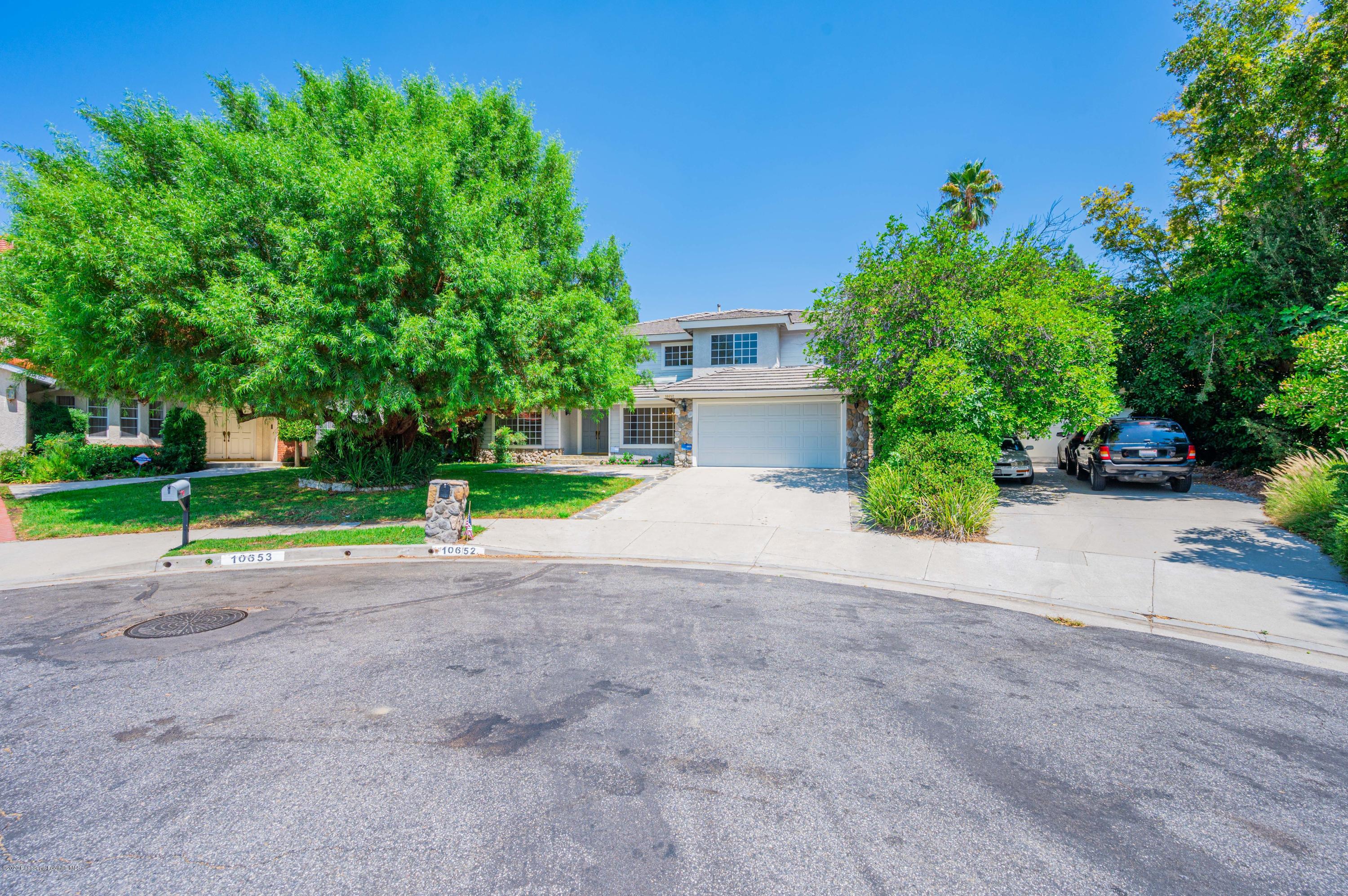 10652 Rathburn Avenue Porter Ranch, CA 91326 - Photo 4 of 61 a view of a house with a yard and plant