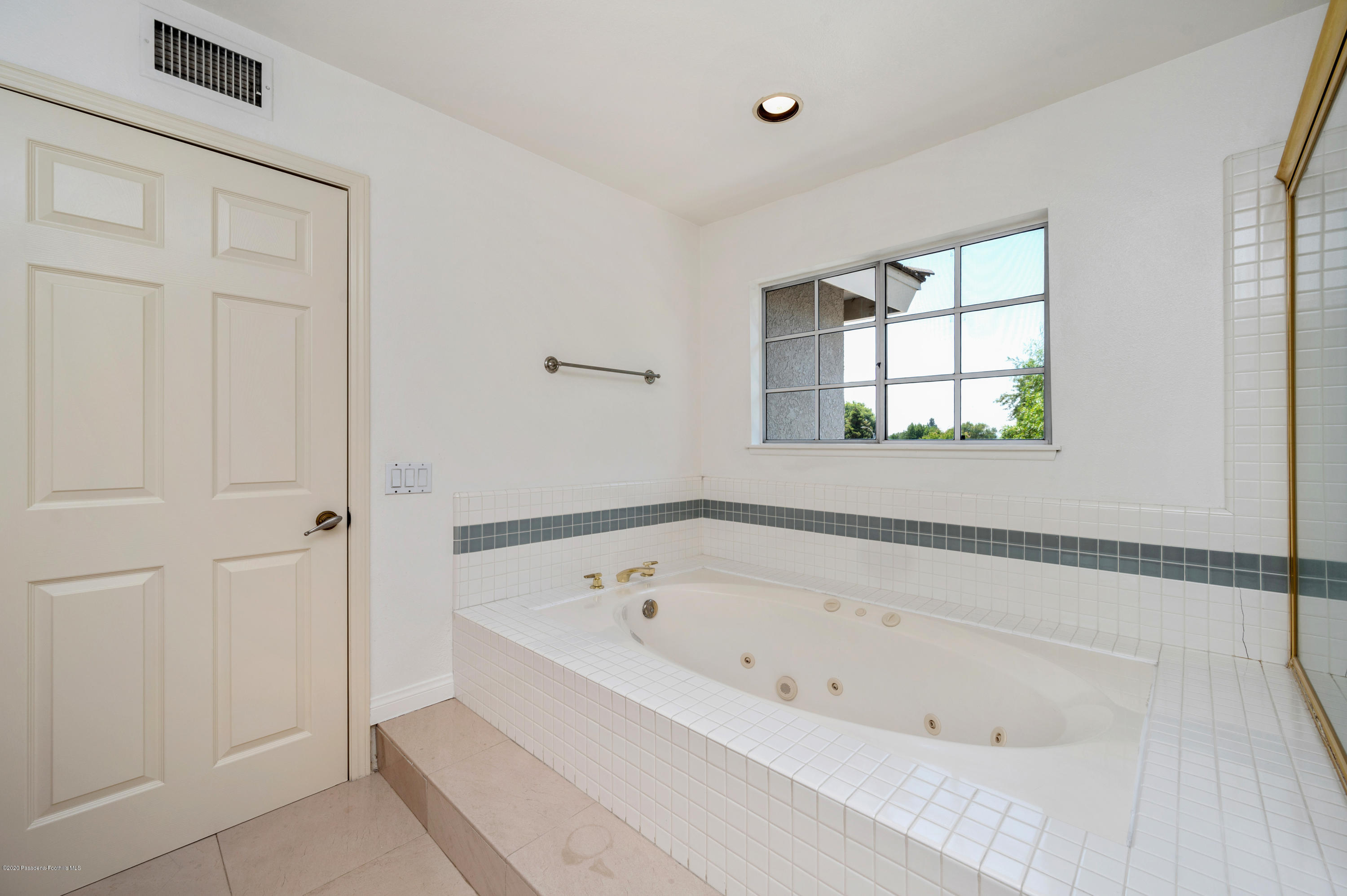 10652 Rathburn Avenue Porter Ranch, CA 91326 - Photo 31 of 61 a white bath tub sitting next to a window