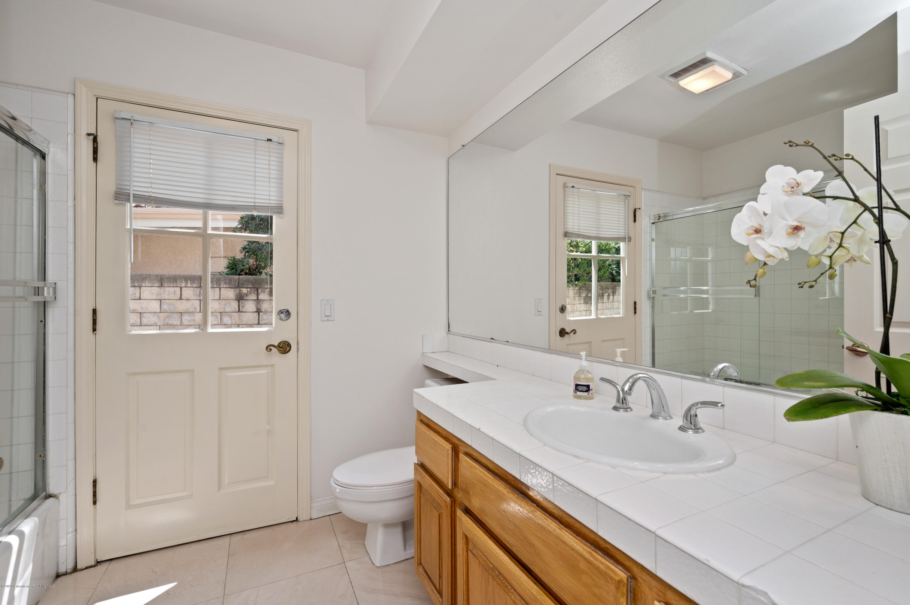 10652 Rathburn Avenue Porter Ranch, CA 91326 - Photo 36 of 61 a bathroom with a sink a toilet and a mirror