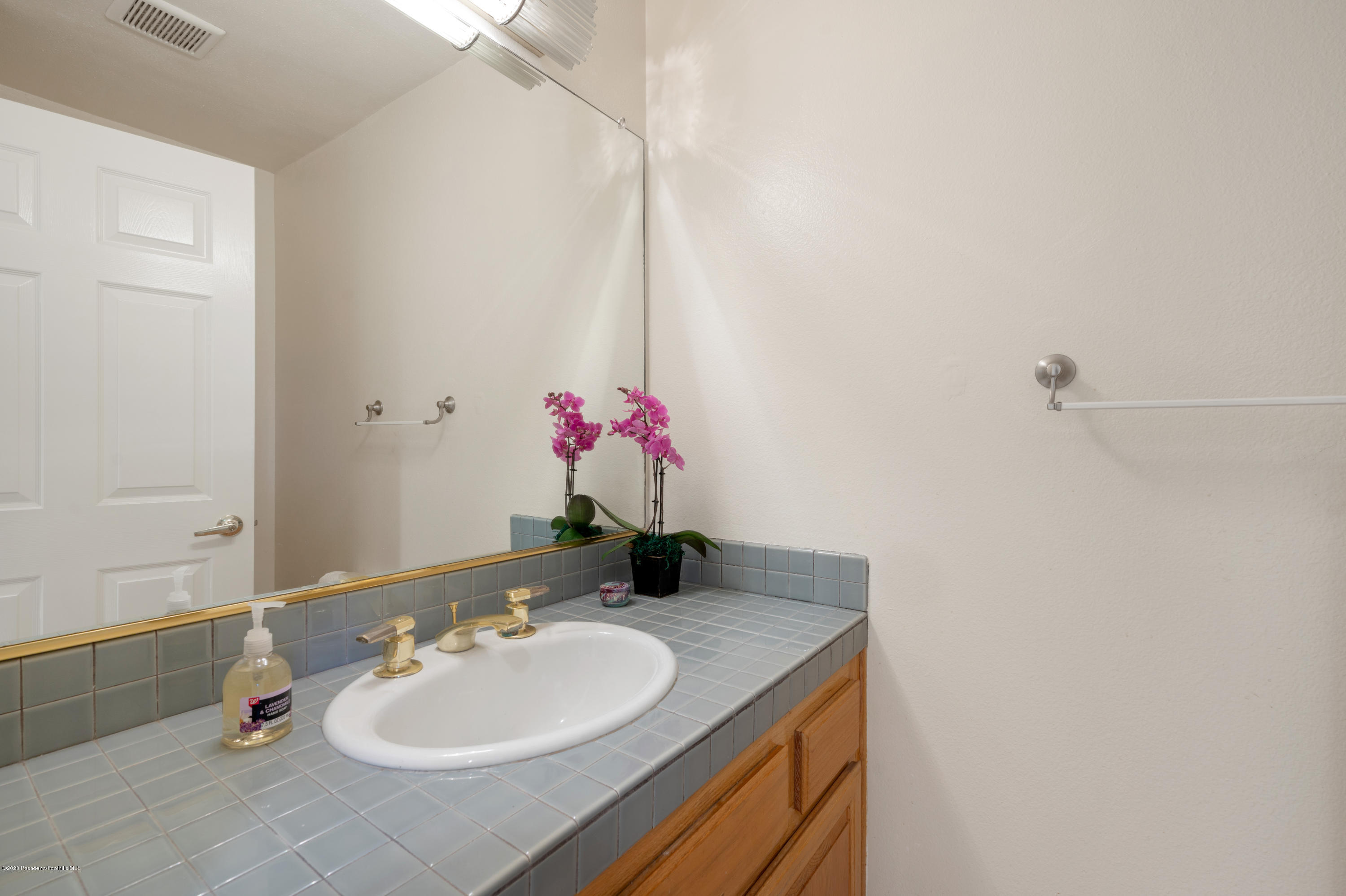 10652 Rathburn Avenue Porter Ranch, CA 91326 - Photo 39 of 61 a bathroom with a sink vanity and a mirror