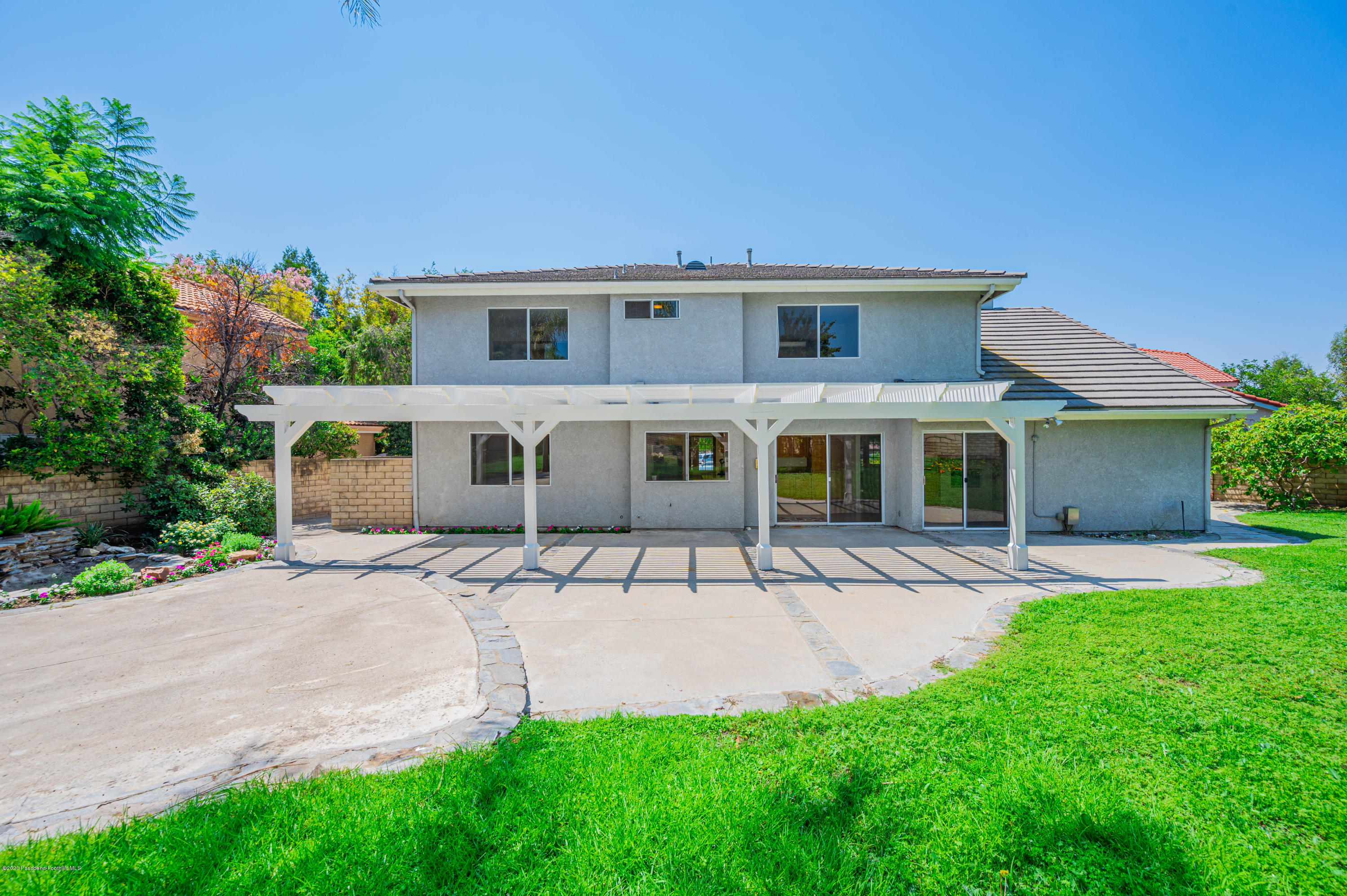 10652 Rathburn Avenue Porter Ranch, CA 91326 - Photo 41 of 61 a front view of a house with a yard and garage