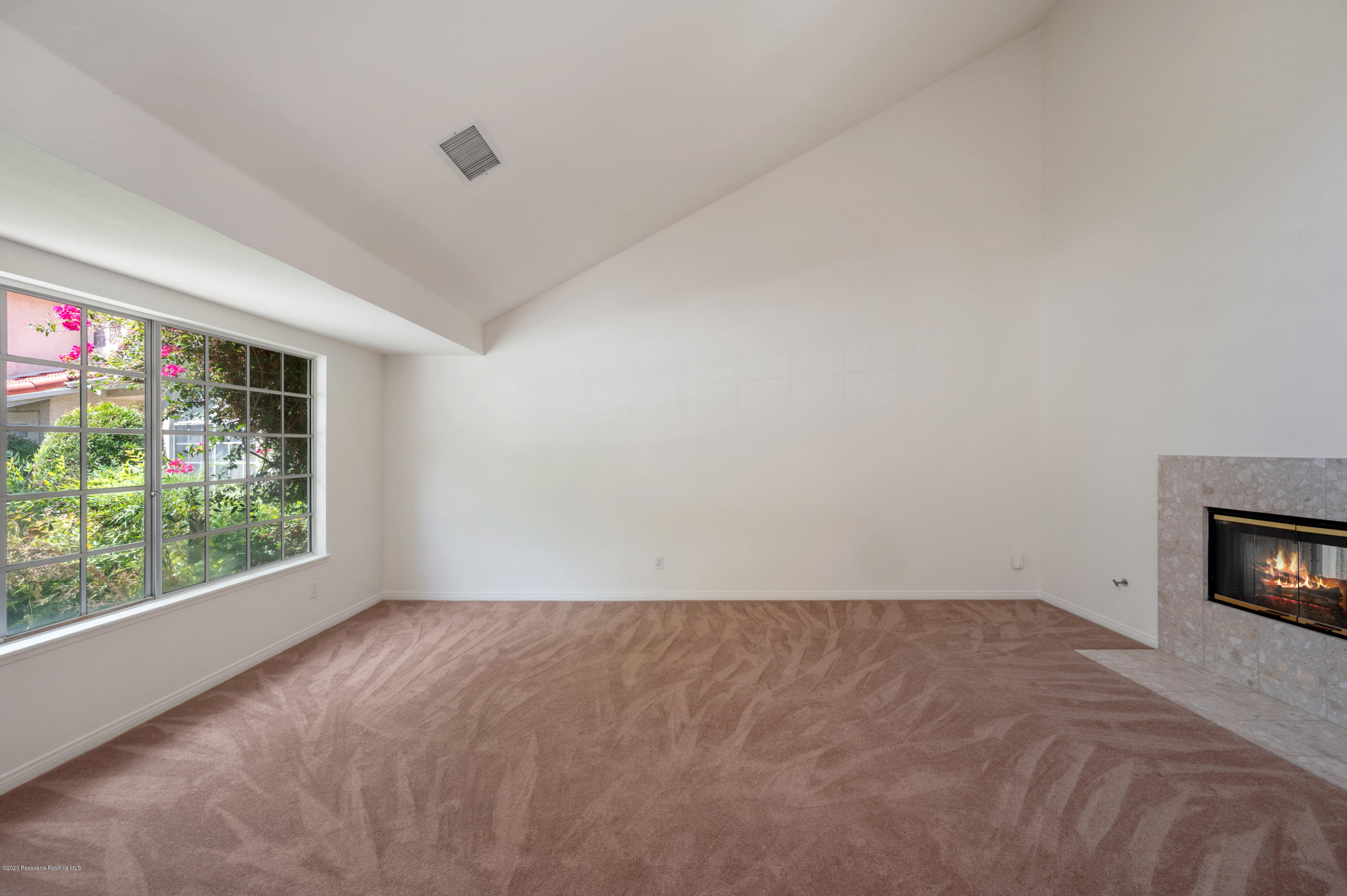 10652 Rathburn Avenue Porter Ranch, CA 91326 - Photo 8 of 61 a view of empty room with window and fireplace