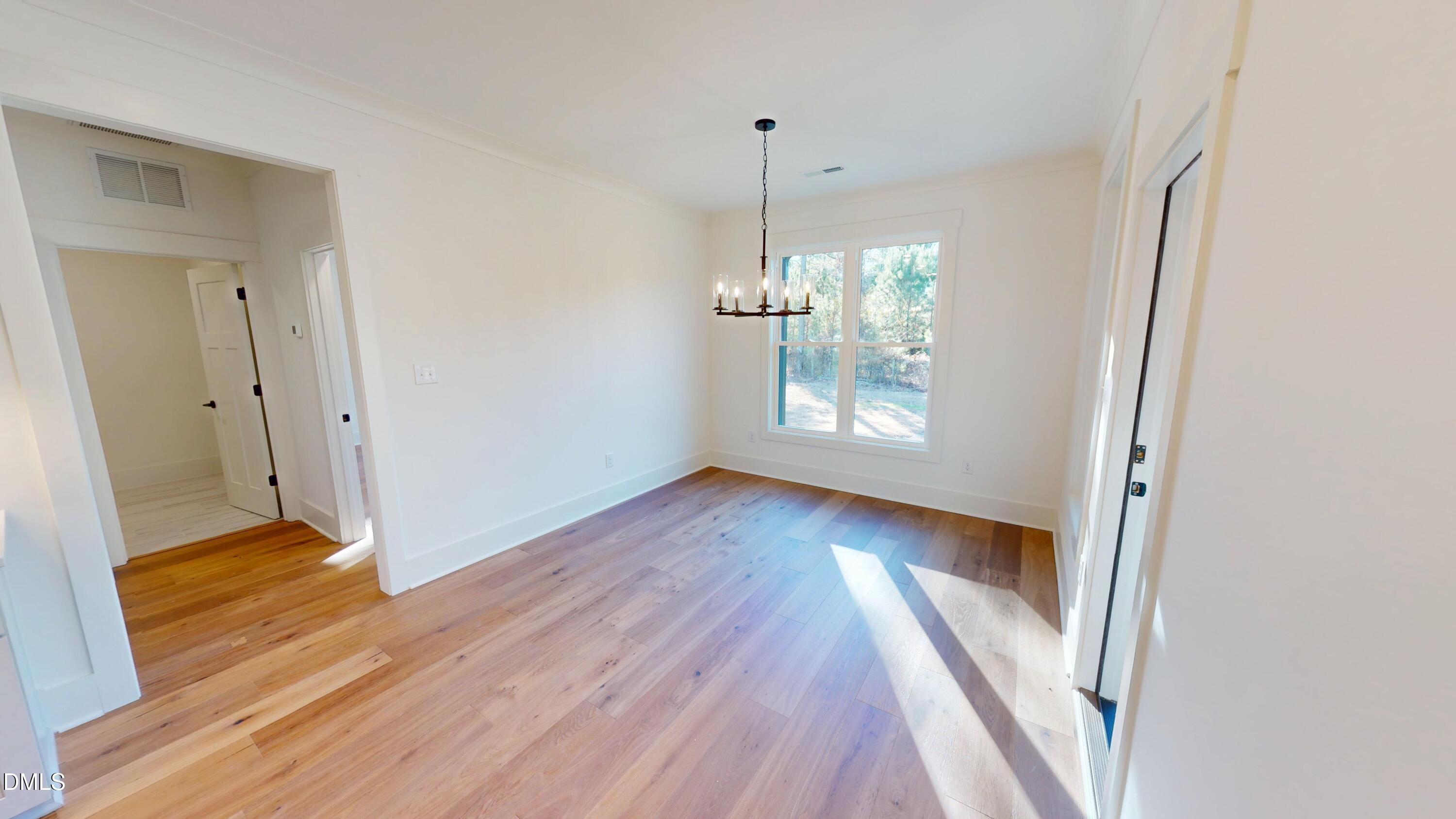 5009 Hopkins Chapel Road Zebulon, NC 27597 - Photo 14 of 28 a view of empty room with wooden floor and fan