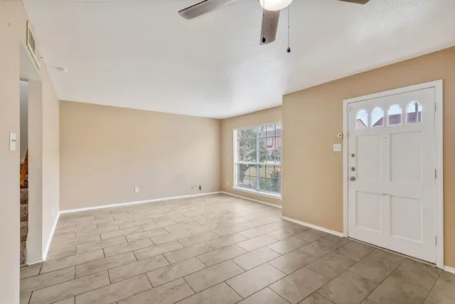 a view of an empty room with a window