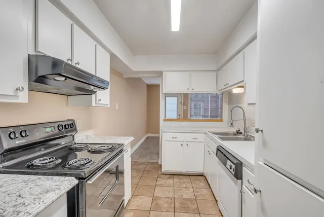 a kitchen with stainless steel appliances granite countertop a stove and a sink