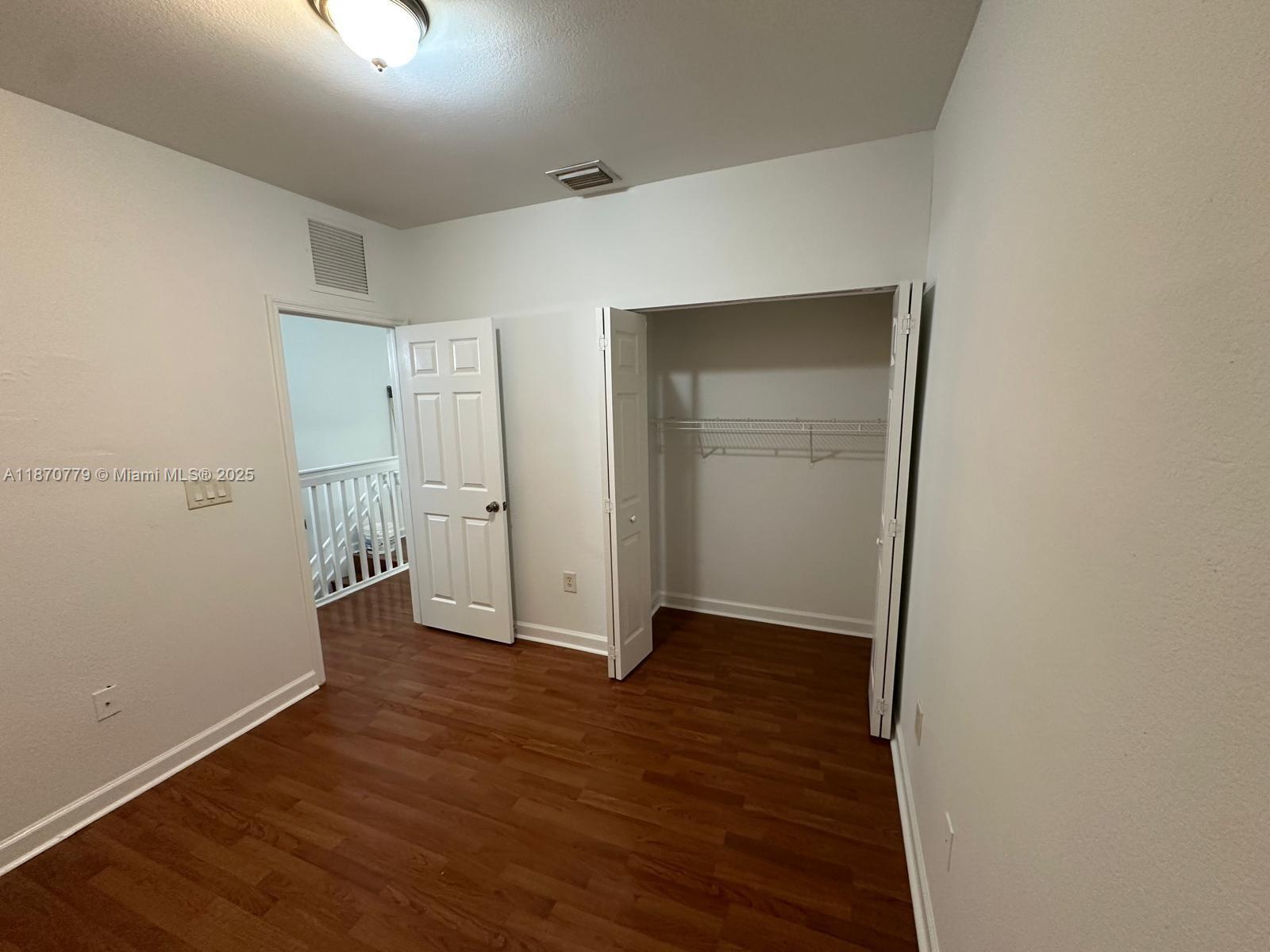 1555 Northeast 33rd Road, Unit 1042 Homestead, FL 33033 - Photo 12 of 19 an empty room with wooden floor