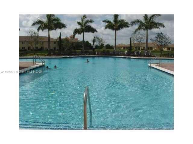 1555 Northeast 33rd Road, Unit 1042 Homestead, FL 33033 - Photo 13 of 19 a bathroom with a sink and a mirror
