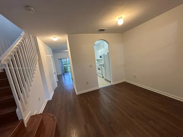 an entryway in a hall with wooden floor