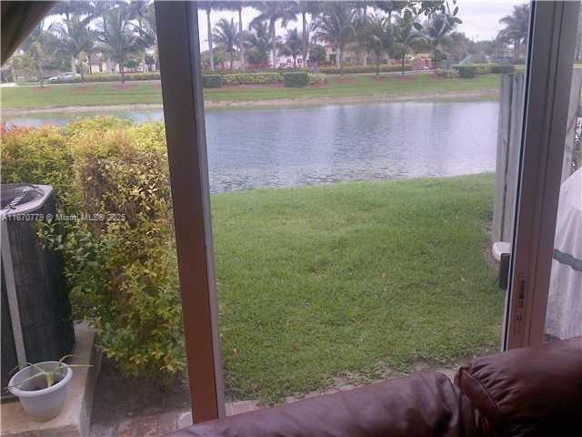 1555 Northeast 33rd Road, Unit 1042 Homestead, FL 33033 - Photo 3 of 19 a view of a lake view with a garden and plants