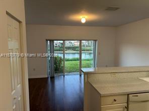 1555 Northeast 33rd Road, Unit 1042 Homestead, FL 33033 - Photo 5 of 19 view of room with window and wooden floor