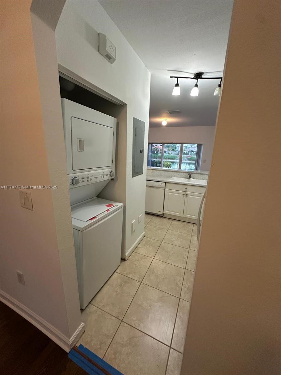 1555 Northeast 33rd Road, Unit 1042 Homestead, FL 33033 - Photo 7 of 19 a room with a washer and dryer