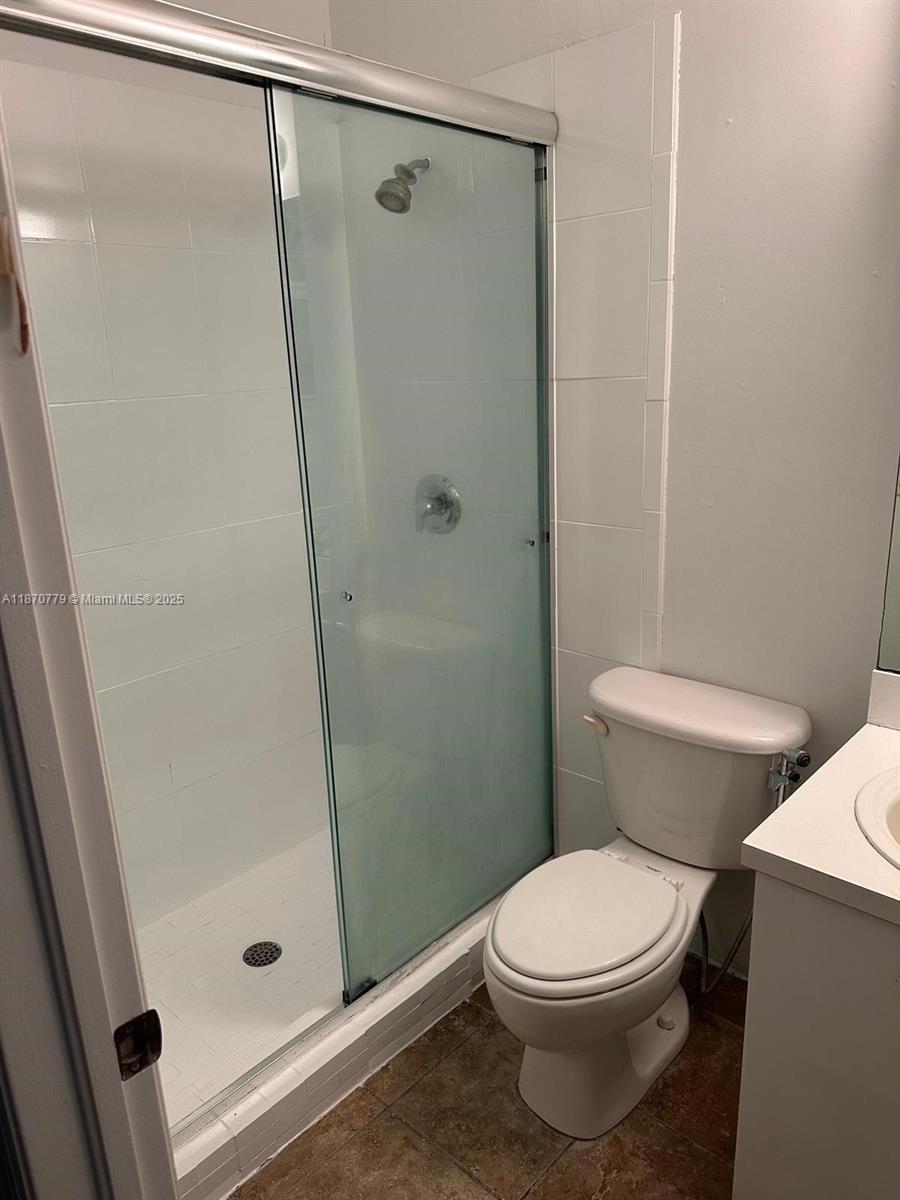 1555 Northeast 33rd Road, Unit 1042 Homestead, FL 33033 - Photo 9 of 19 a bathroom with a toilet and a shower