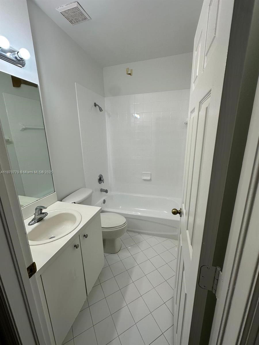 1555 Northeast 33rd Road, Unit 1042 Homestead, FL 33033 - Photo 10 of 19 a bathroom with a sink toilet and shower