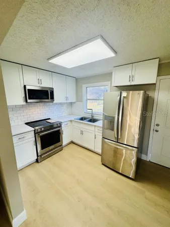 a kitchen with a refrigerator sink and microwave