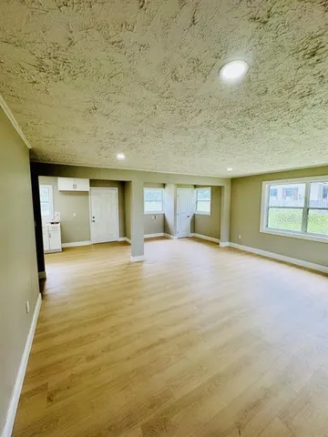 a view of an empty room with a fireplace