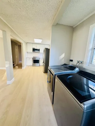 a kitchen with a sink appliances and cabinets