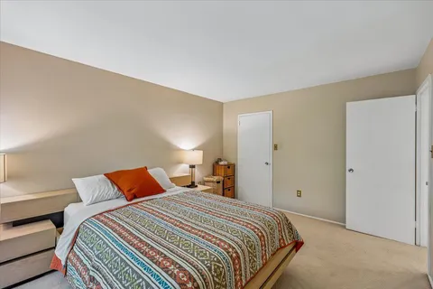 a bedroom with a bed and a lamp