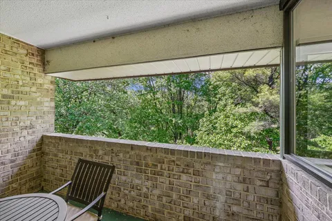 a view of a chair and table in the balcony