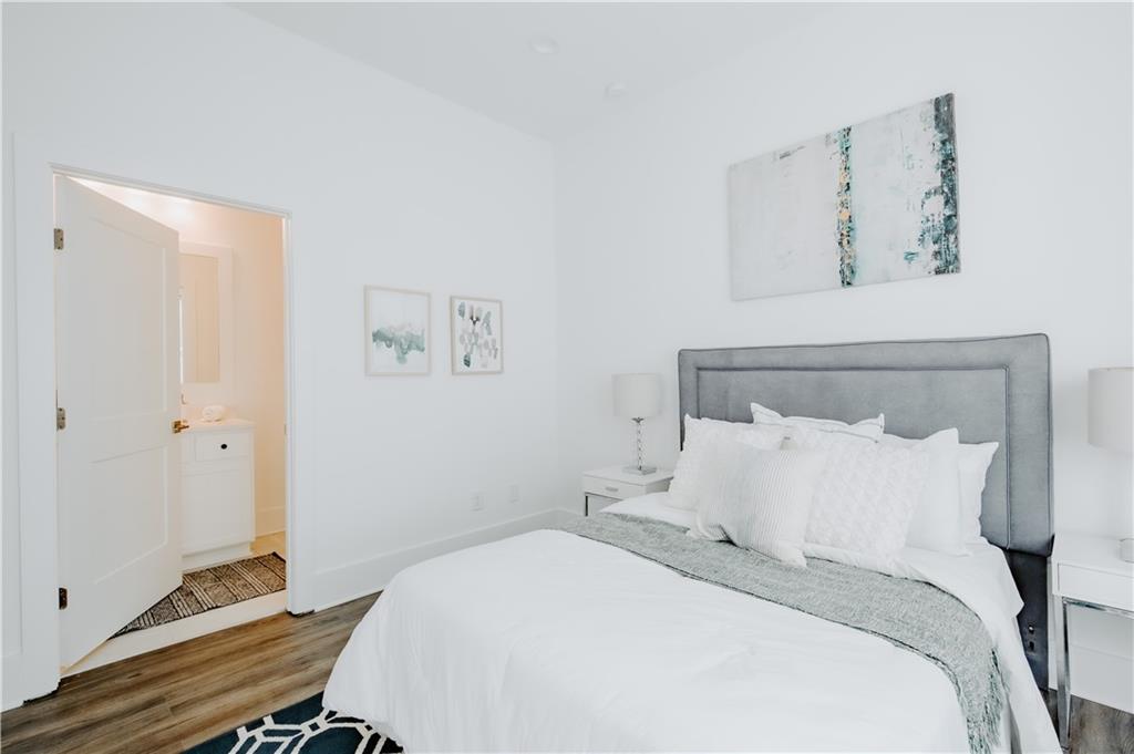 117 Mayson Avenue Northeast, Unit C Atlanta, GA 30307 - Photo 11 of 30 a bedroom with a bed and a window