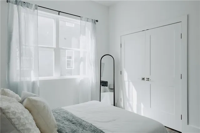 a bedroom with a bed and a dresser