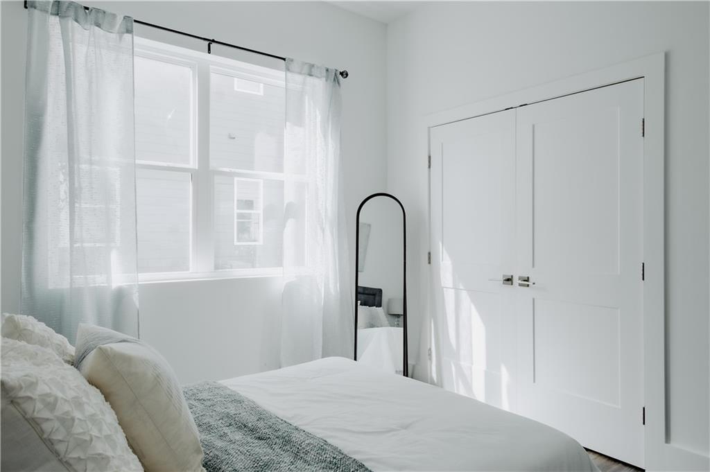 117 Mayson Avenue Northeast, Unit C Atlanta, GA 30307 - Photo 12 of 30 a bedroom with a bed and a dresser