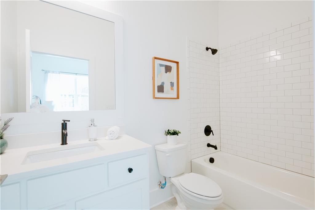 117 Mayson Avenue Northeast, Unit C Atlanta, GA 30307 - Photo 13 of 30 a bathroom with a sink a toilet and shower
