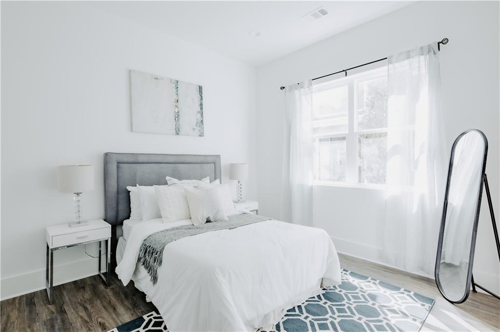 117 Mayson Avenue Northeast, Unit C Atlanta, GA 30307 - Photo 15 of 30 a bedroom with a bed and a window
