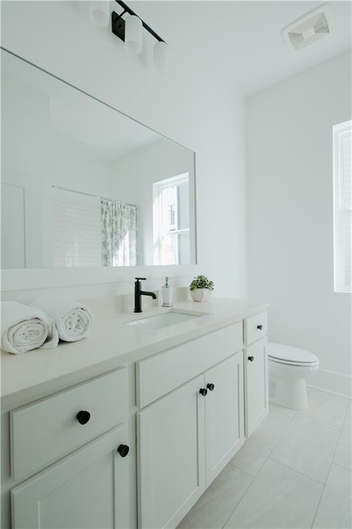 117 Mayson Avenue Northeast, Unit C Atlanta, GA 30307 - Photo 20 of 30 a bathroom with a double vanity sink and mirror