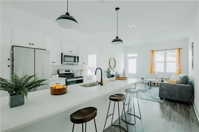 a very nice looking living room with a couch and a potted plant