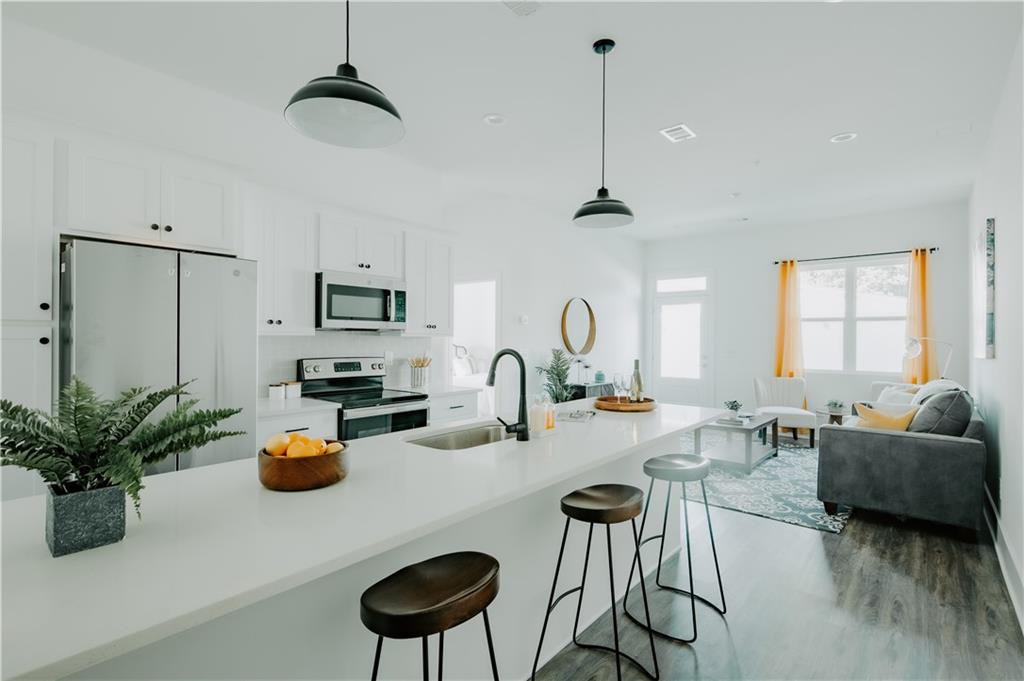 117 Mayson Avenue Northeast, Unit C Atlanta, GA 30307 - Photo 3 of 30 a very nice looking living room with a couch and a potted plant