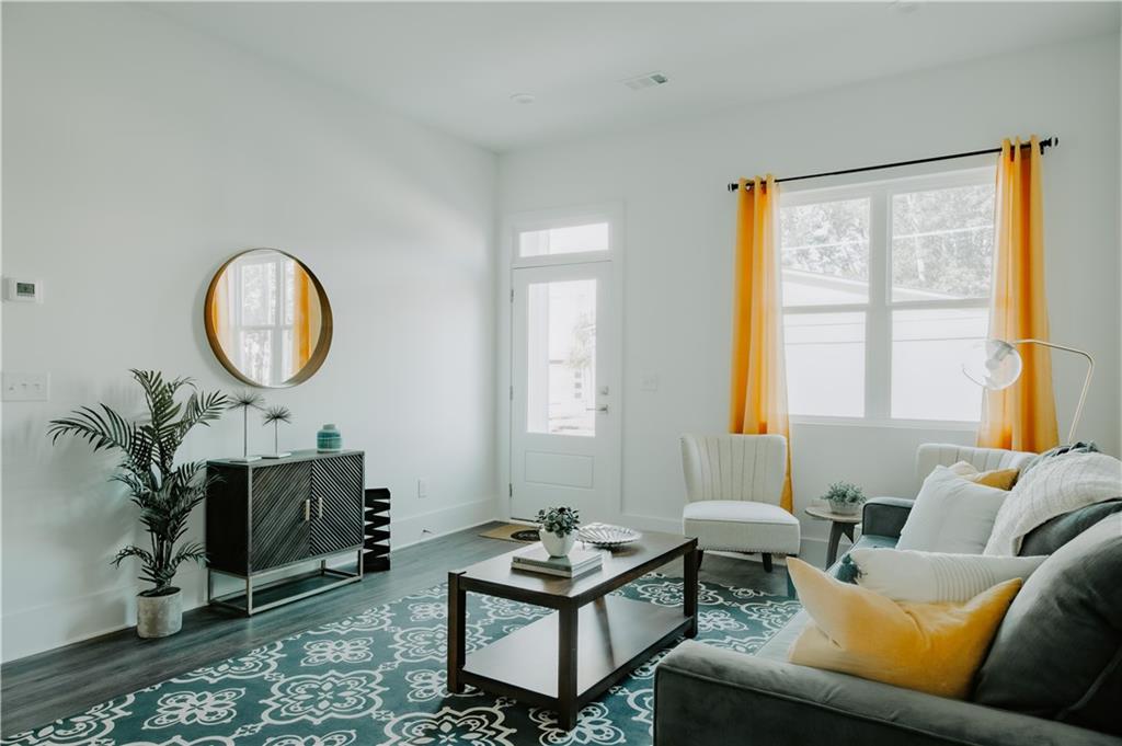 117 Mayson Avenue Northeast, Unit C Atlanta, GA 30307 - Photo 5 of 30 a living room with furniture and a large window