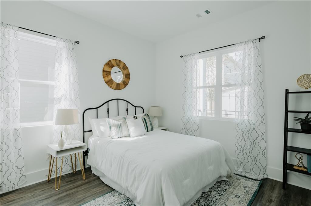 117 Mayson Avenue Northeast, Unit C Atlanta, GA 30307 - Photo 7 of 30 a bedroom with a bed and a window