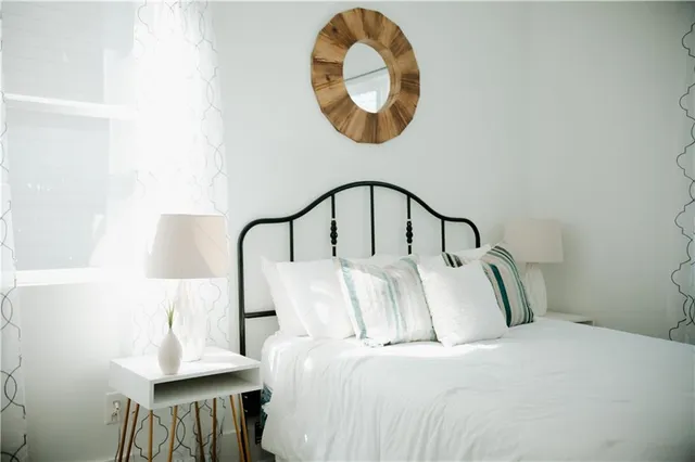 a bedroom with bed and a a mirror