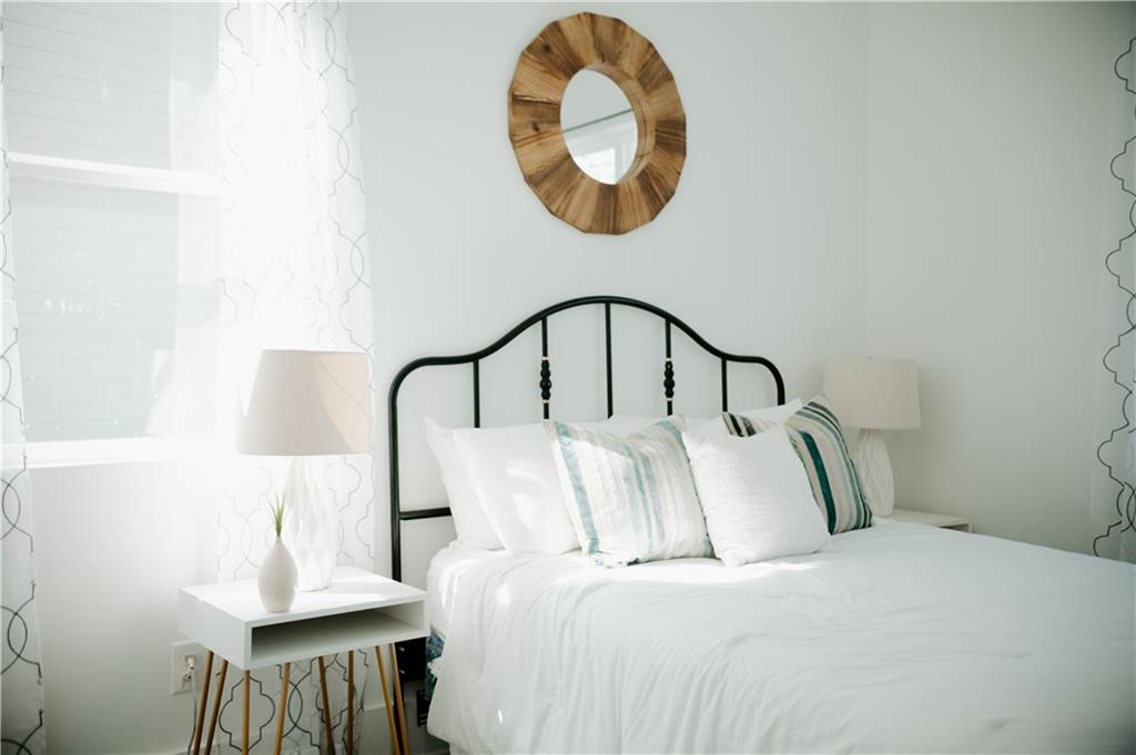 117 Mayson Avenue Northeast, Unit C Atlanta, GA 30307 - Photo 8 of 30 a bedroom with bed and a a mirror