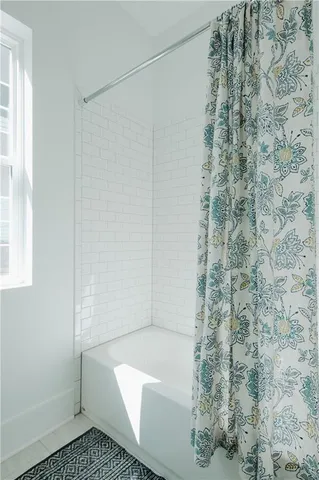 a bathroom with a bathtub and shower