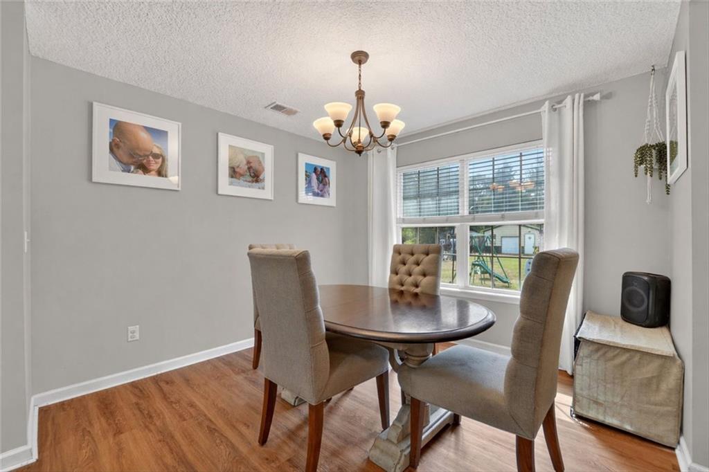 359 Poole Road Ludowici, GA 31316 - Photo 15 of 49 a dining room with furniture a chandelier and wooden floor