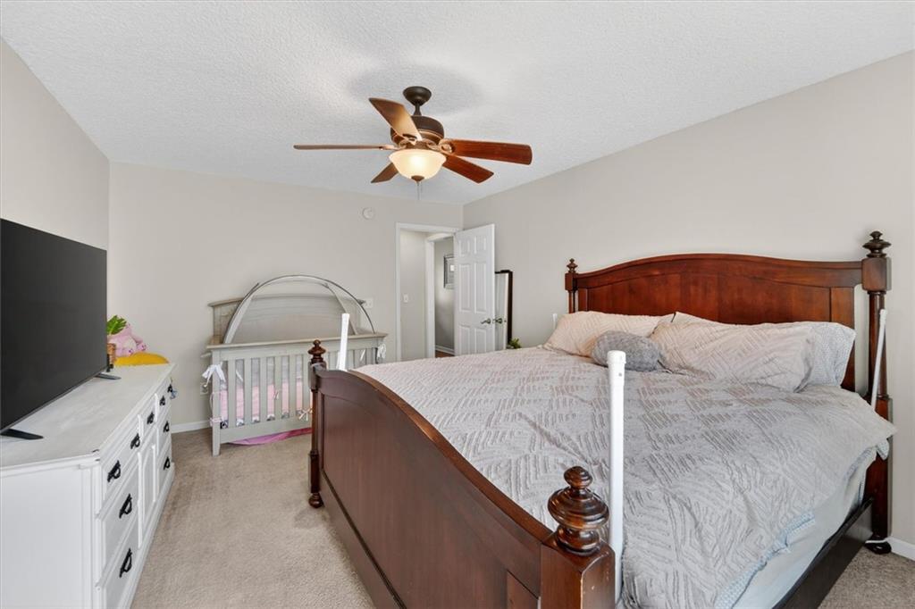 359 Poole Road Ludowici, GA 31316 - Photo 18 of 49 a bedroom with a bed and a flat tv screen on the dresser