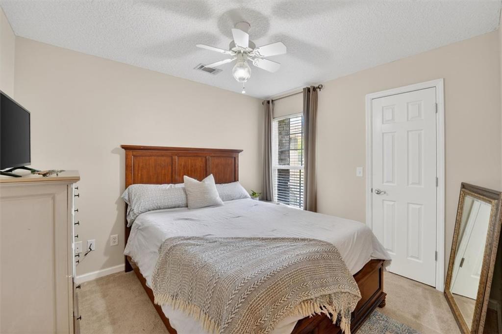 359 Poole Road Ludowici, GA 31316 - Photo 22 of 49 a bedroom with a large bed and a chandelier