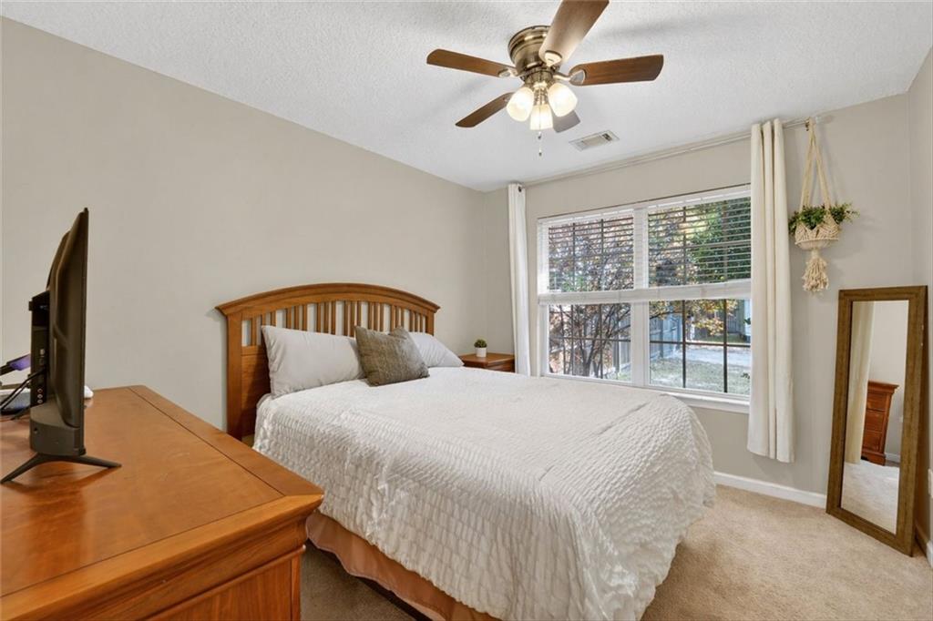 359 Poole Road Ludowici, GA 31316 - Photo 26 of 49 a bedroom with a large bed and a flat tv screen on dresser