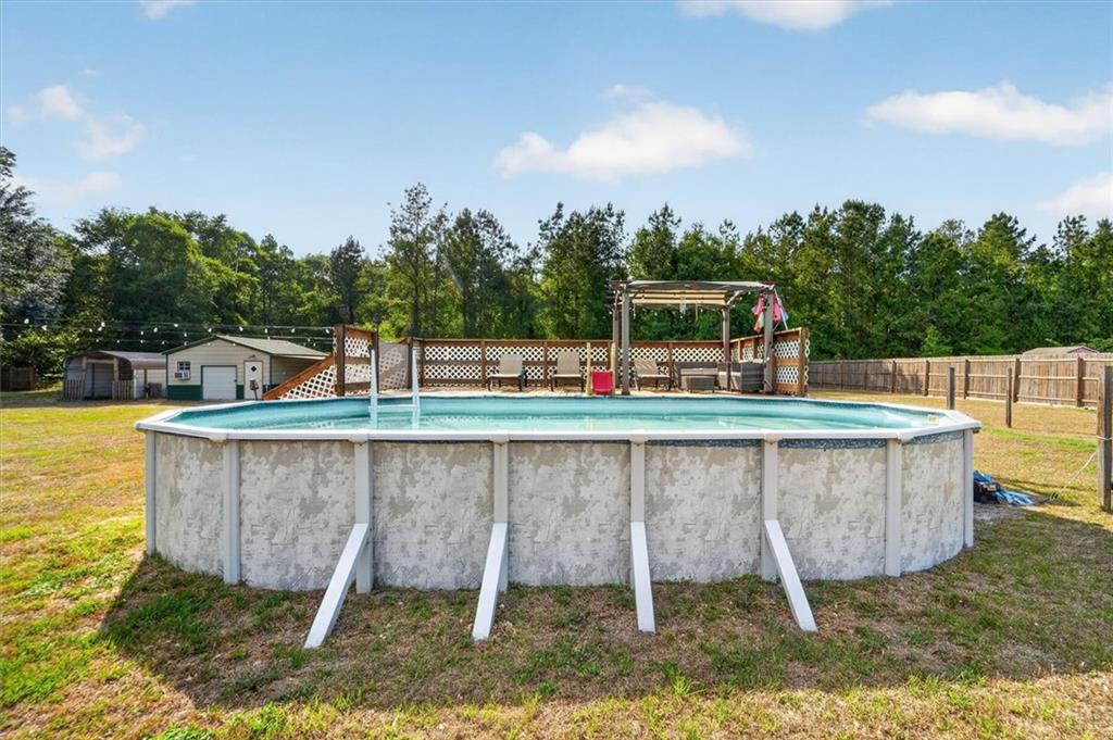 359 Poole Road Ludowici, GA 31316 - Photo 42 of 49 a view of a swimming pool with a lounge chair