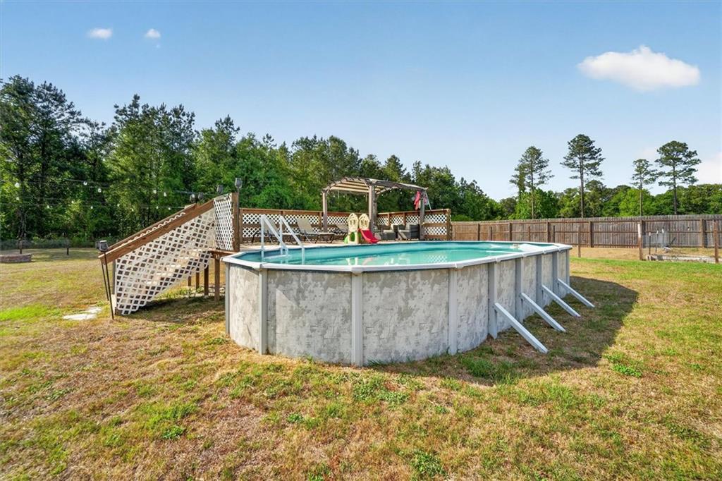 359 Poole Road Ludowici, GA 31316 - Photo 43 of 49 a view of a swimming pool with a patio and a yard