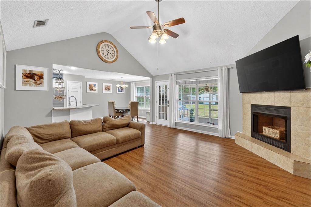 359 Poole Road Ludowici, GA 31316 - Photo 7 of 49 a living room with furniture a flat screen tv and a fireplace