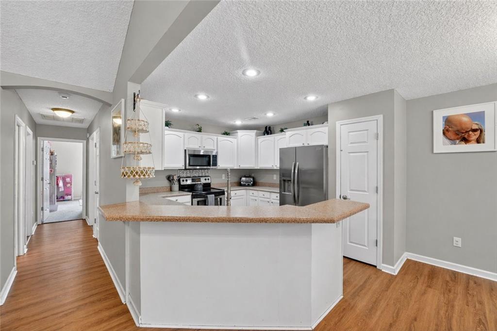 359 Poole Road Ludowici, GA 31316 - Photo 9 of 49 a view of kitchen with kitchen island stainless steel appliances refrigerator stove microwave and cabinets