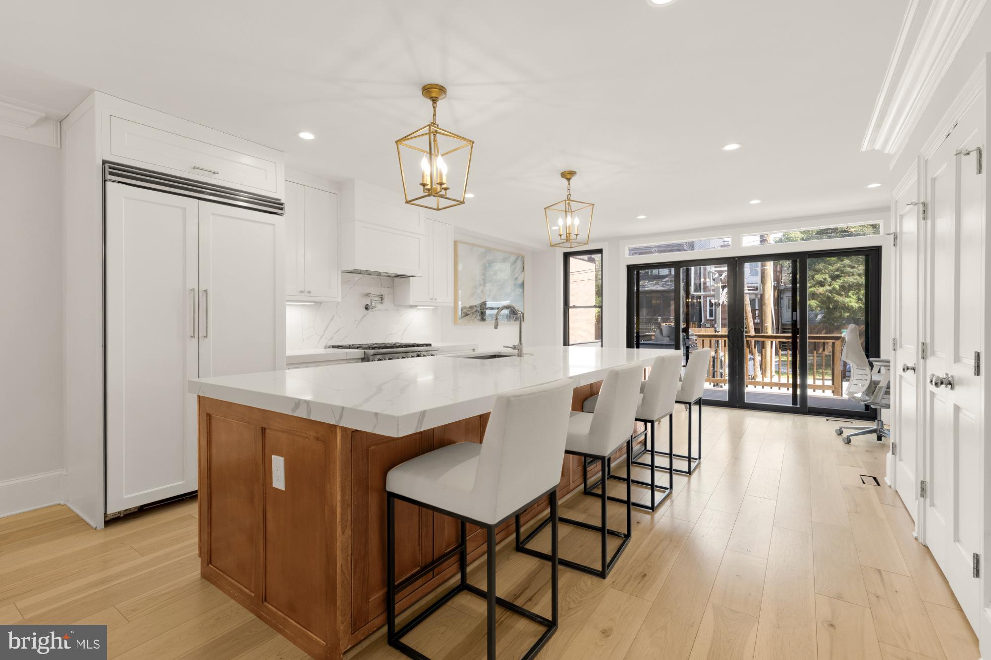 3705 Reservoir Road Northwest Washington, DC 20007 - Photo 11 of 45 a kitchen with stainless steel appliances kitchen island granite countertop a table chairs and a refrigerator